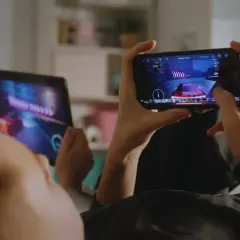 Dzieci grają w fajne gry na telefonie i tablecie, ścigając się w wirtualnym świecie.